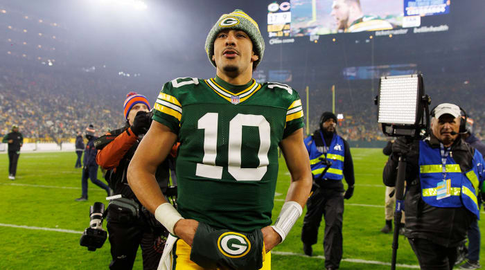 Jordan Love leaving the field after a win to clinch a playoff spot